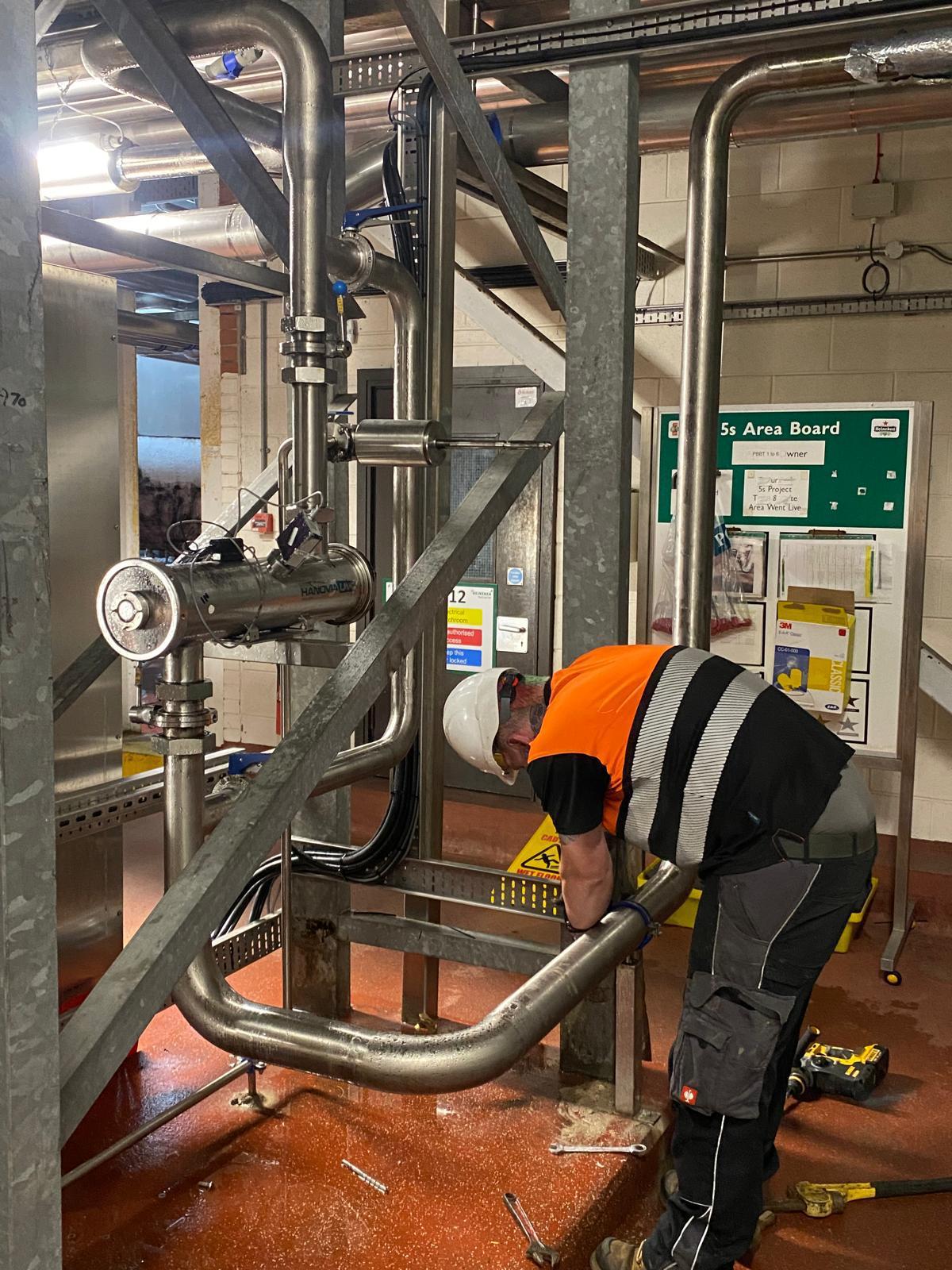 Willand engineer installing stainless steel process pipework on a live production site